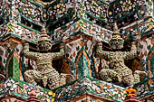 Bangkok Wat Arun - Statues of the mythical  demon bears  that support the different levels of the Phra prang. 